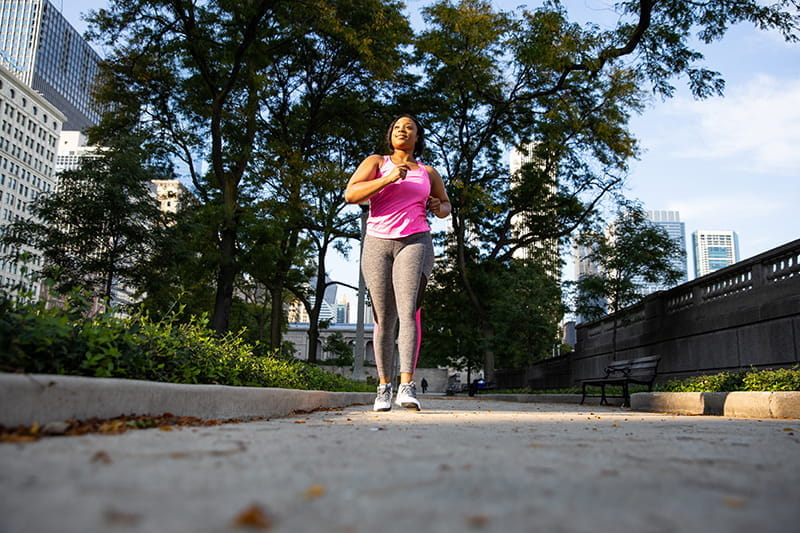 woman walking on sidewalk downtown