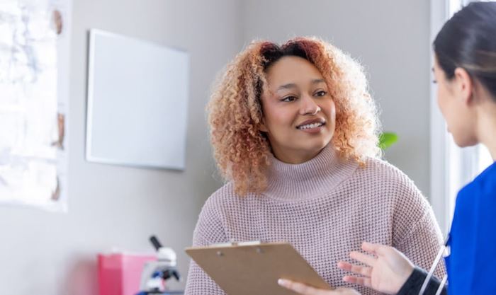Women talking to her health care professional in a medical office