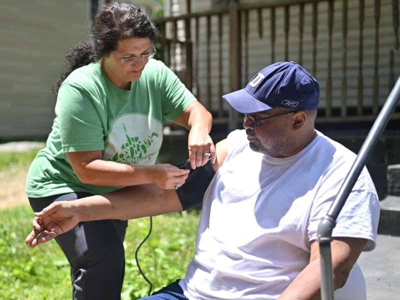 Melissa Justice, a registered nurse and community health worker coordinator at Williamson Health and Wellness Center, helps Craig Warren stay on top of his blood pressure.