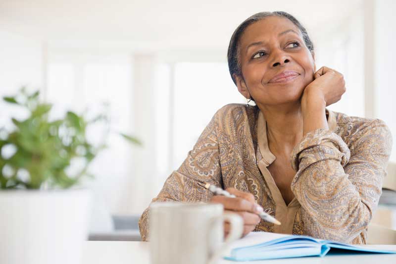 Older woman writing in journal