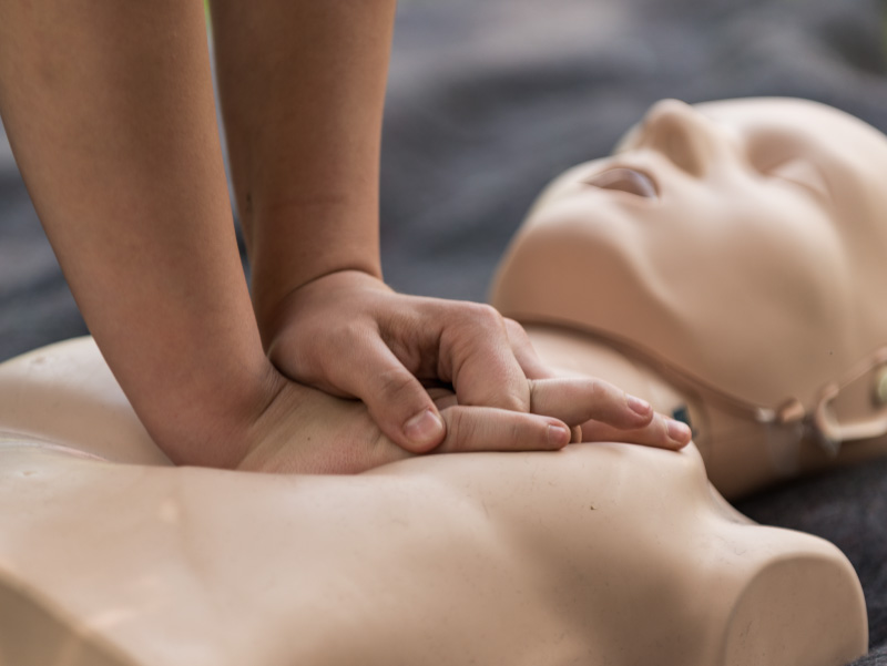 Hands on a CPR manikin.