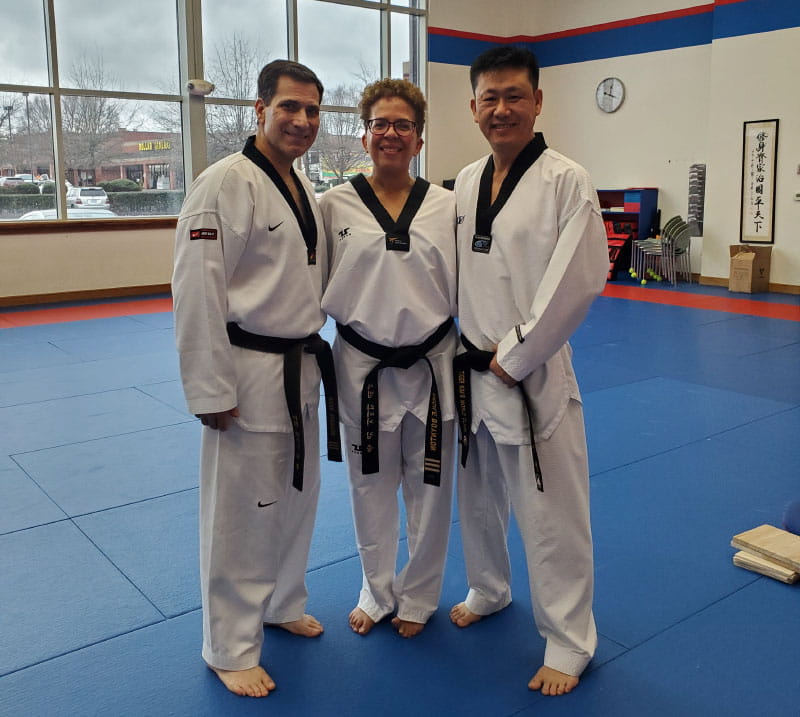 Cécile and Mark Boynton with their taekwondo instructor, Mark Wright, earlier this year. (Photo courtesy of Cécile Boynton)