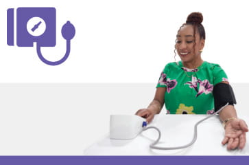 Woman taking her blood pressure at home Woman taking her blood pressure at home