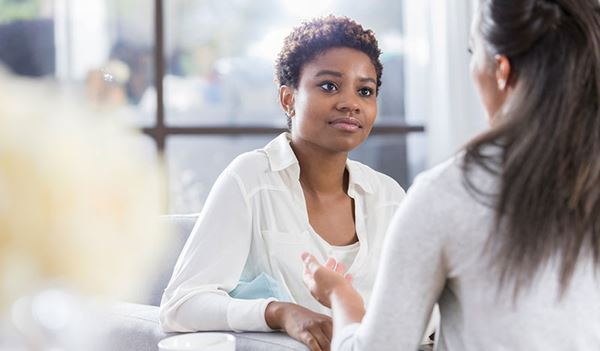 young woman listening to friend