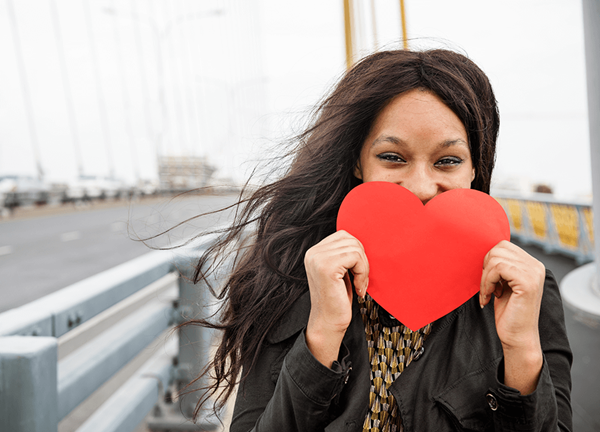 Woman holding paper heart shape