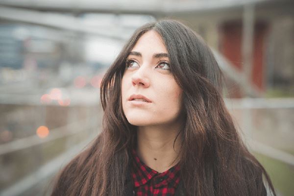 young woman with long hair contemplating the fragile nature of life young woman with long hair contemplating the fragile nature of life