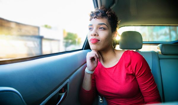 peaceful woman looks out car window peaceful woman looks out car window