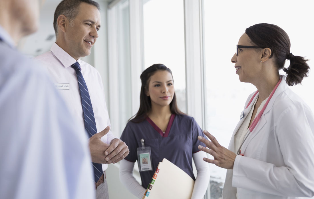 Two doctors and a nurse having a discussion