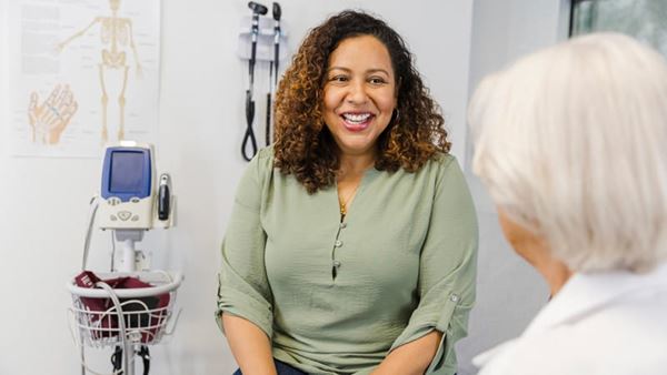 Senior female doctor talking with female patient
