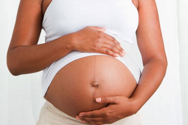 Pregnant woman cradling her belly
